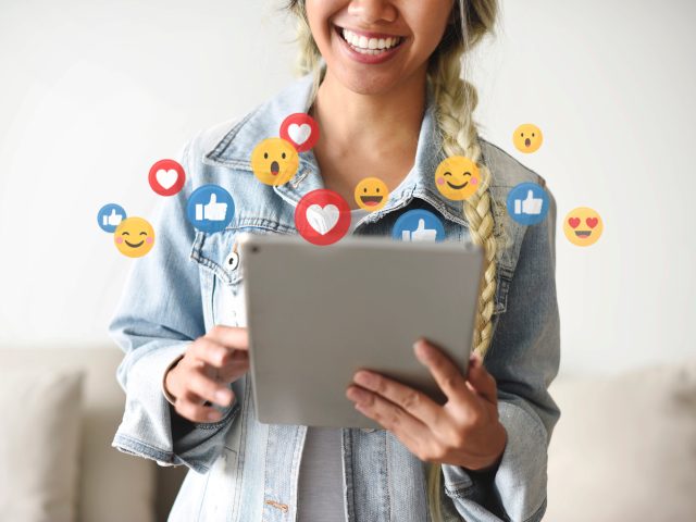 Cheerful woman watching a live video Cheerful woman watching a live video
